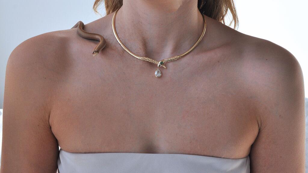 Ashley Zhang Jewelry’s one-of-a-kind “Snake” necklace features a 14-karat yellow gold omega chain with two round brilliant-cut diamonds for its eyes, a pear-cut emerald on its head, and a 2-carat pear-cut diamond drop dangling from its mouth ($28,000). Ashley Zhang 2025 Lunar New Year Snake Necklace Campaign